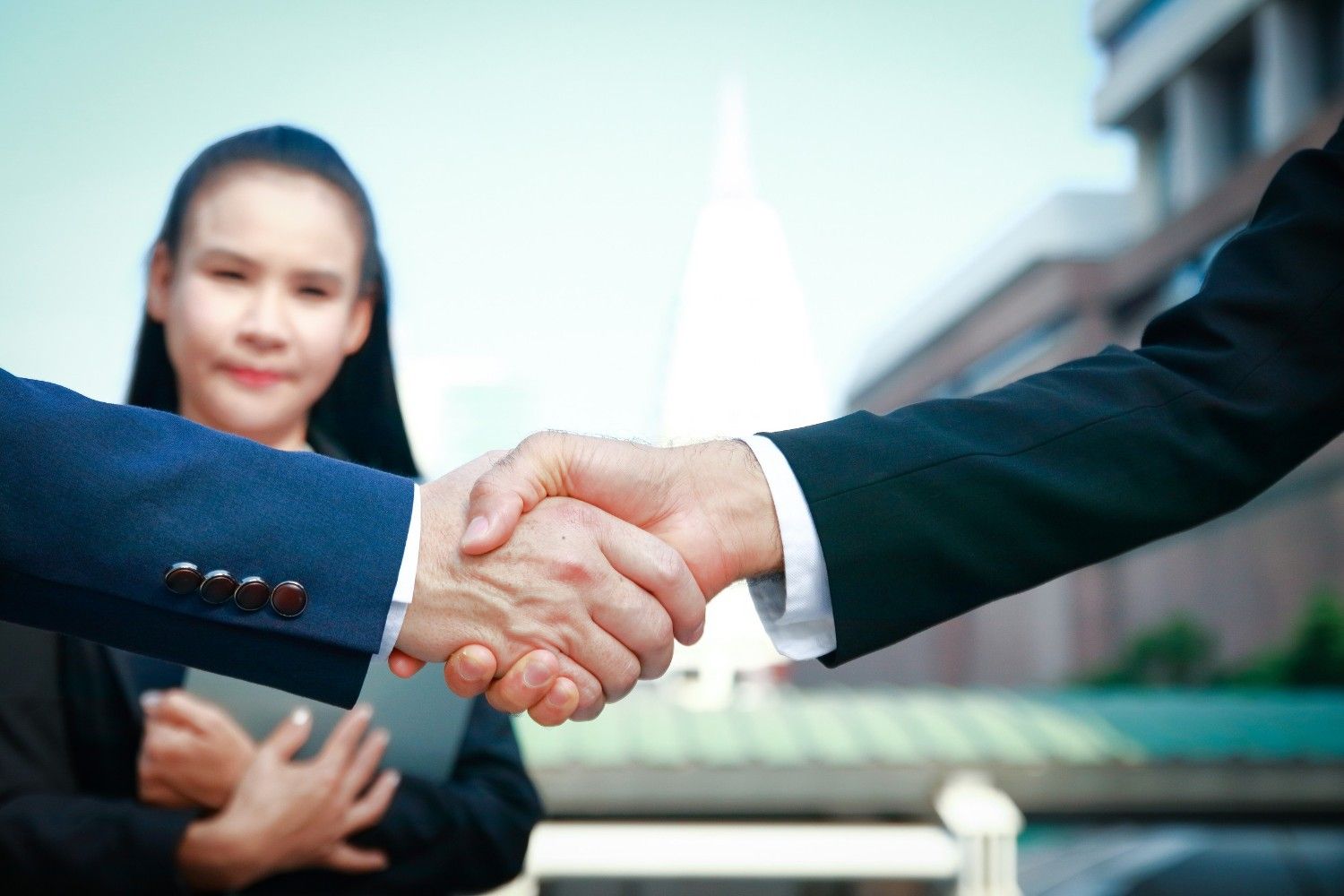 Asian Businessmen Stand Hand In Hand