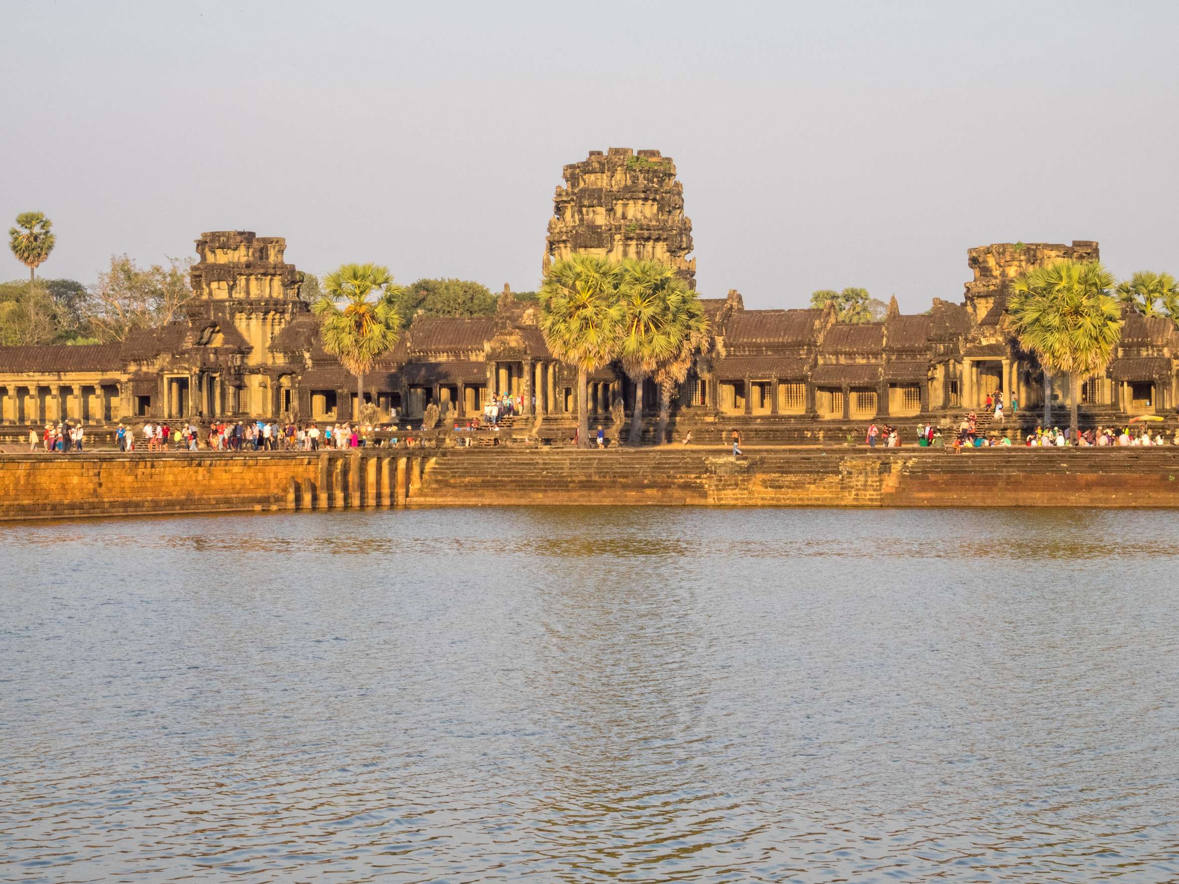 Historic Angkor Wat temple with palm trees