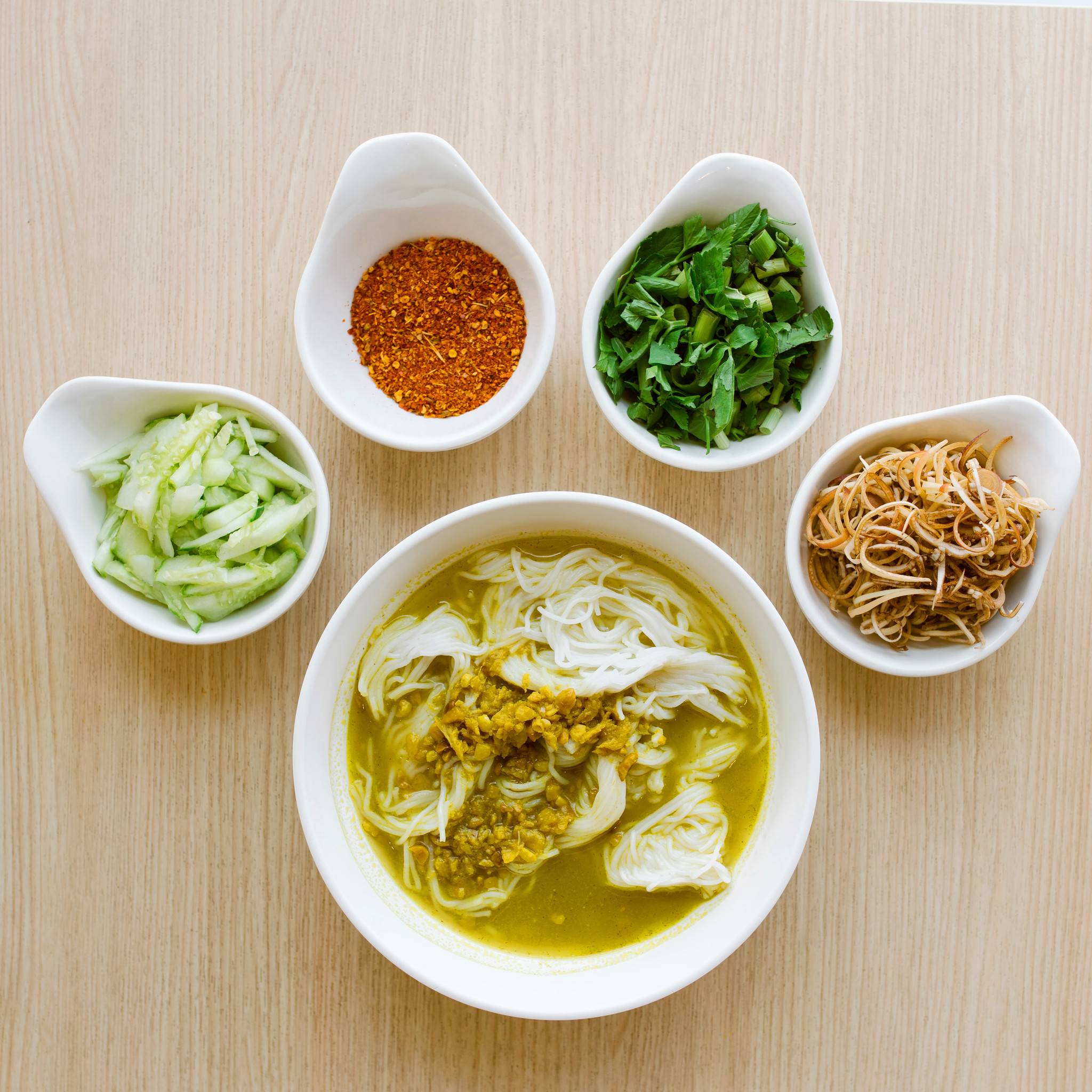 Khmer noodle dish with side condiments