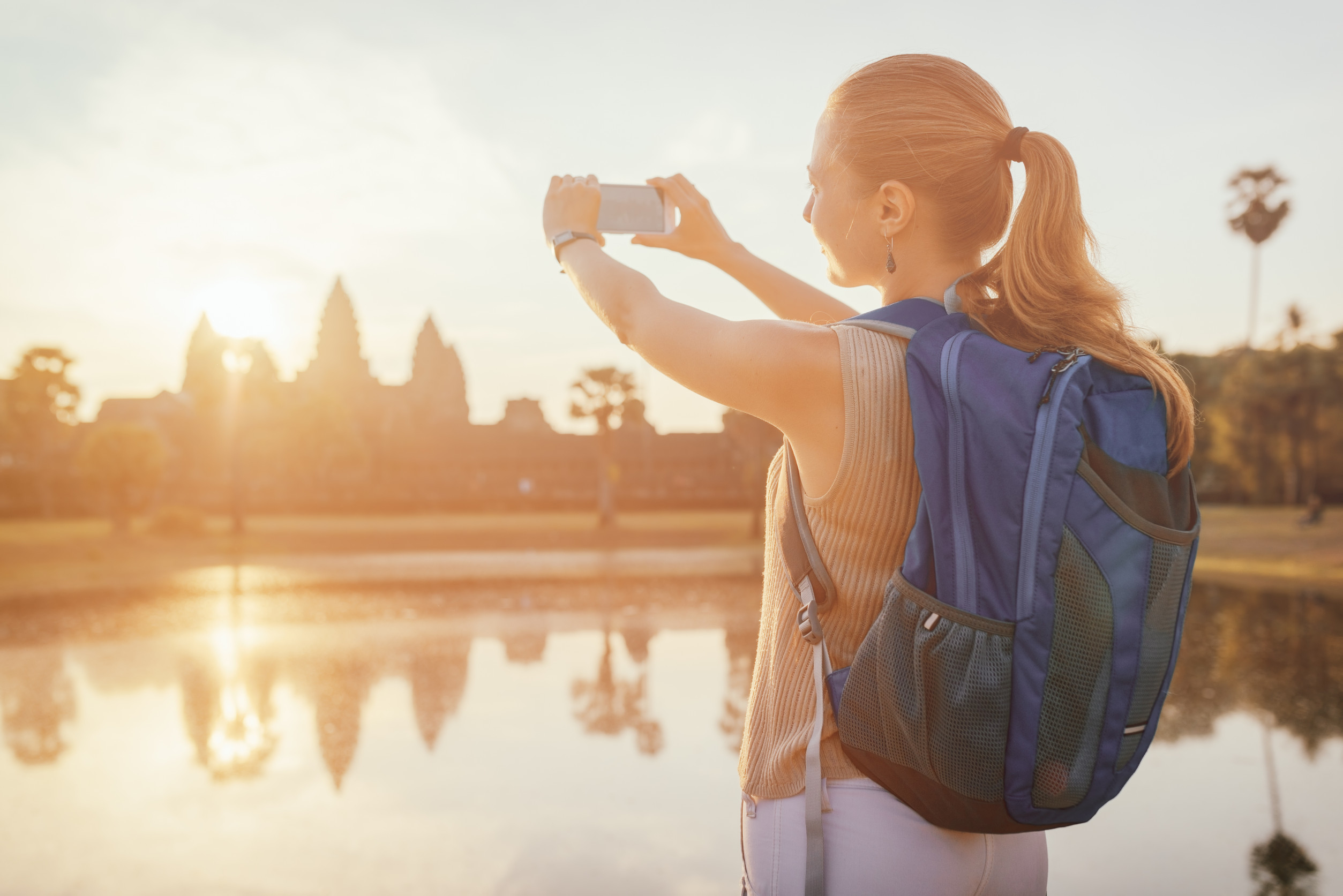 Young Female Tourist Taking Picture With Smartphone